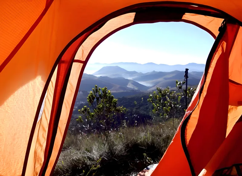 Vista da serra de dentro da barraca num camping da Tribo da Trilha